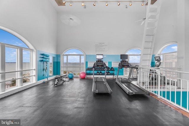 200 59th St Unit 506, Ocean City, MD 21842 - exercise room featuring a healthy amount of sunlight, a ceiling fan, and a high ceiling