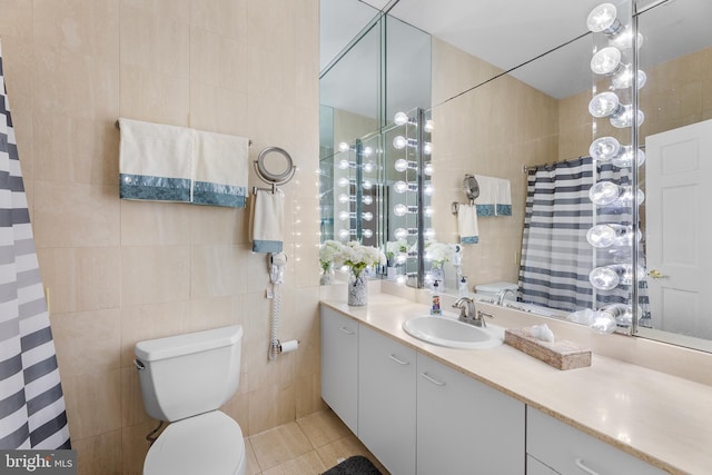 bathroom featuring tile walls, vanity, toilet, and tile patterned flooring