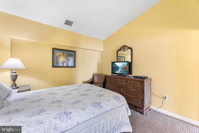 carpeted bedroom with lofted ceiling