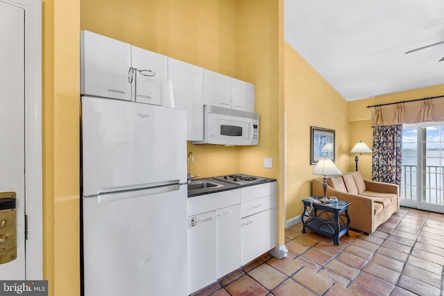 kitchen featuring sink, vaulted ceiling, white cabinetry, white appliances, and ceiling fan