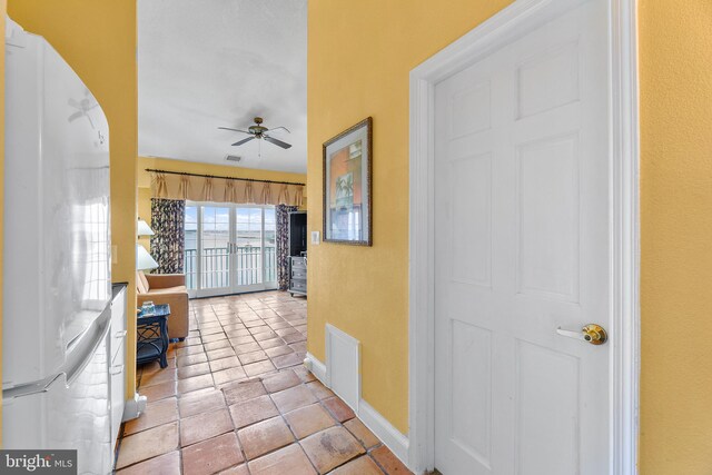 hall with light tile patterned flooring