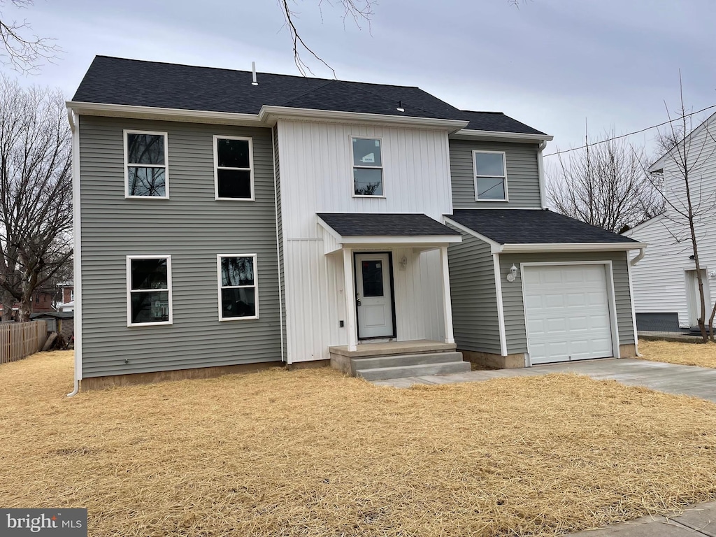 view of front of property with concrete driveway and roof with shingles