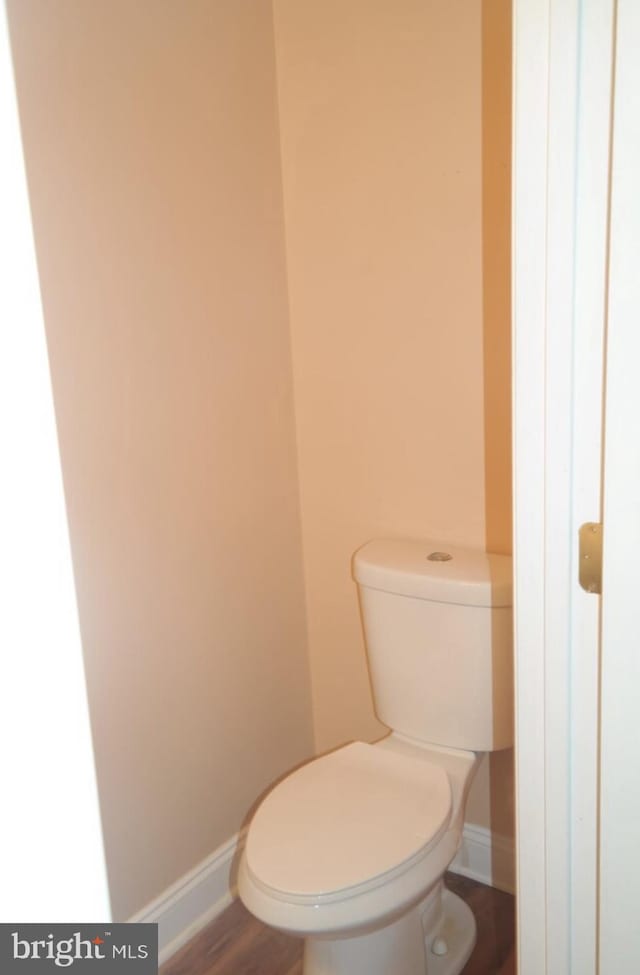 bathroom with toilet and hardwood / wood-style flooring