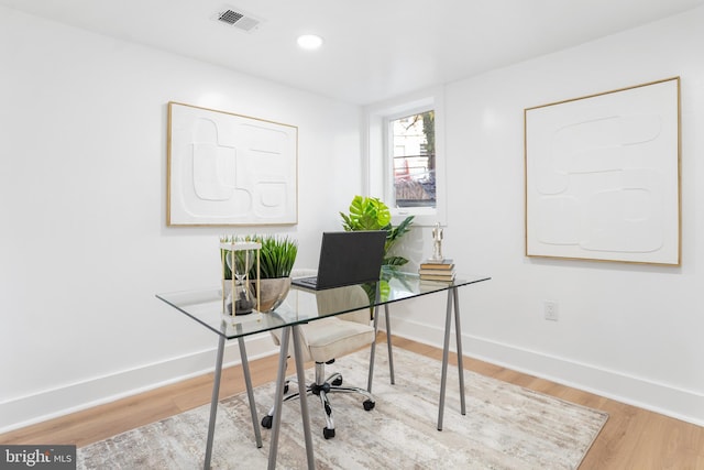 office area with light hardwood / wood-style floors