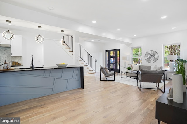 living room with sink and light hardwood / wood-style floors