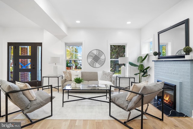 living room featuring light hardwood / wood-style floors and a fireplace