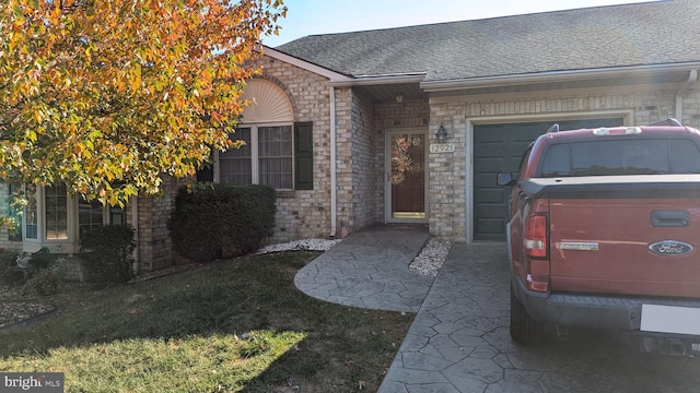 doorway to property with a garage