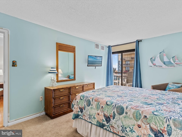 carpeted bedroom featuring a textured ceiling