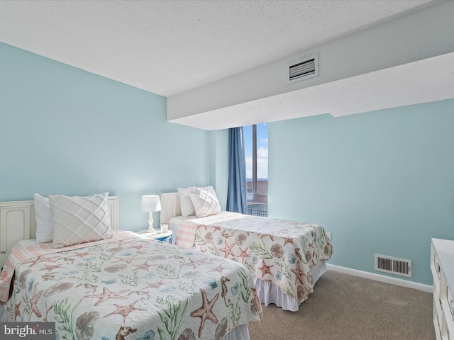 carpeted bedroom with a textured ceiling