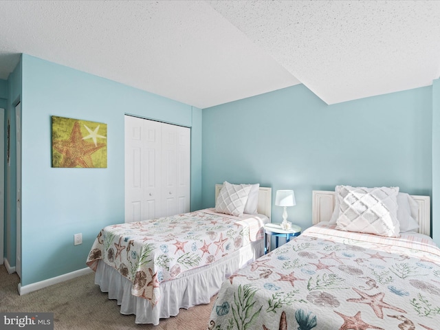 bedroom with light colored carpet, a textured ceiling, and a closet