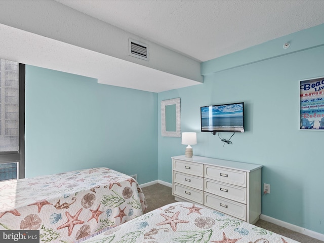 bedroom with carpet and a textured ceiling