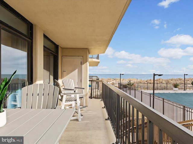 balcony featuring a water view