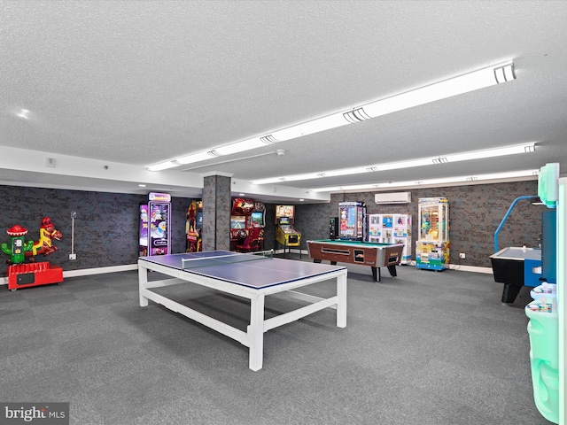 playroom with pool table, a textured ceiling, and a wall mounted AC