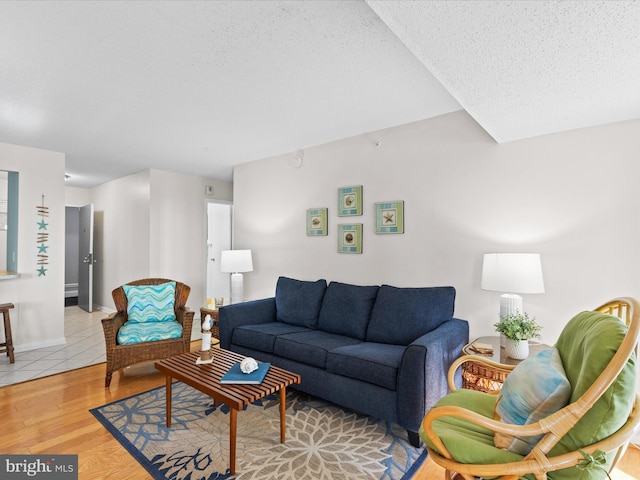 living room featuring a textured ceiling and light hardwood / wood-style flooring