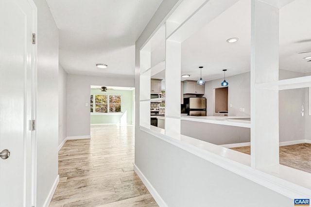 hall with light hardwood / wood-style floors