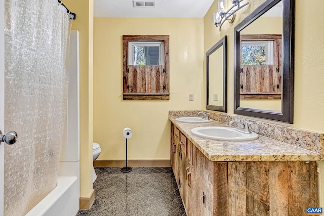 full bathroom featuring vanity, shower / tub combo with curtain, and toilet