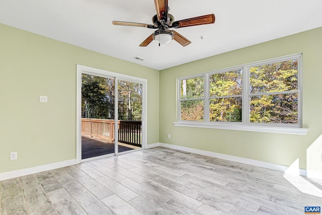 spare room featuring light wood-type flooring and ceiling fan