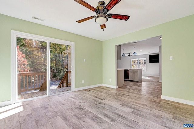 unfurnished living room featuring ceiling fan, light hardwood / wood-style floors, and plenty of natural light