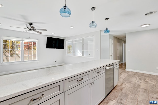 kitchen with hanging light fixtures, ceiling fan, light hardwood / wood-style floors, stainless steel dishwasher, and light stone counters