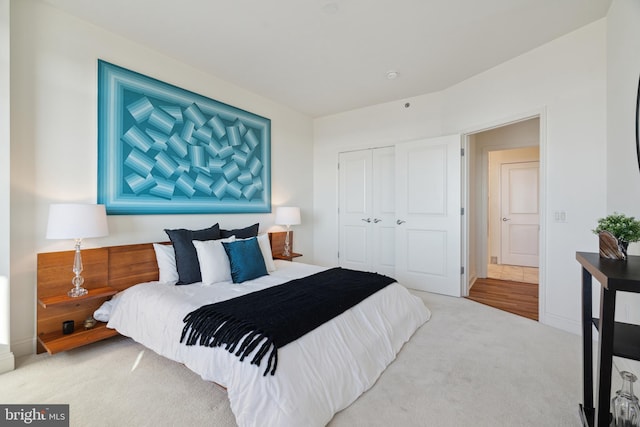 carpeted bedroom with a closet