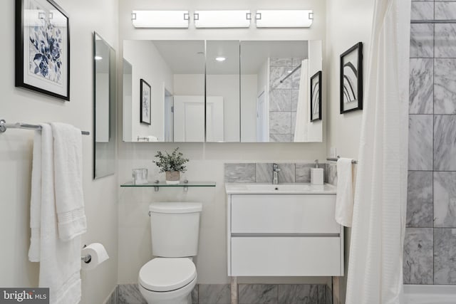 bathroom featuring curtained shower, vanity, and toilet