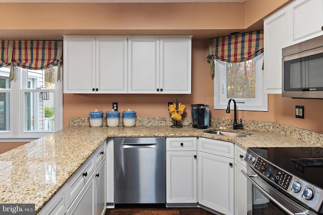 kitchen featuring white cabinetry, sink, and appliances with stainless steel finishes