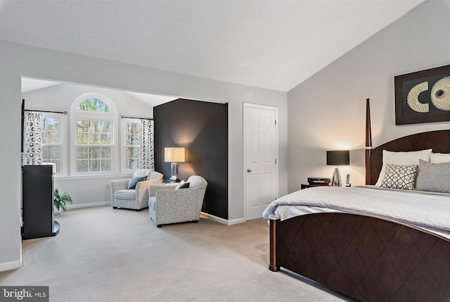 carpeted bedroom with vaulted ceiling