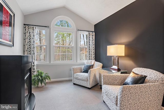 living area with light colored carpet and lofted ceiling