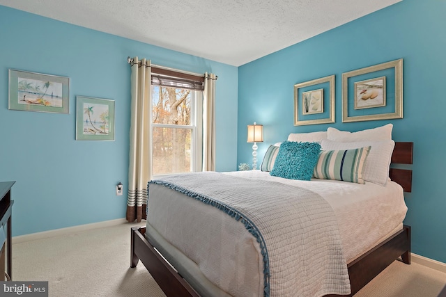 carpeted bedroom featuring a textured ceiling