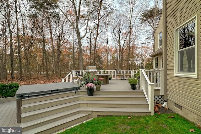 wooden deck featuring a hot tub