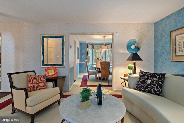 living room featuring carpet and a textured ceiling