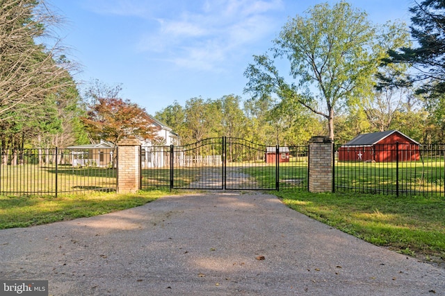 view of gate featuring a lawn