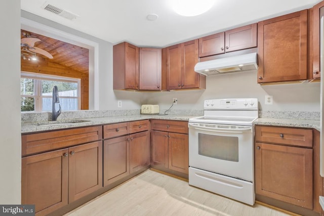 kitchen featuring white range with electric cooktop, light stone counters, vaulted ceiling, sink, and light hardwood / wood-style flooring