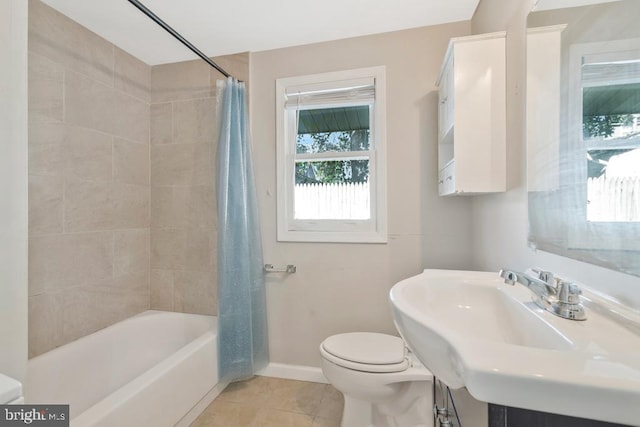 full bathroom featuring tile patterned floors, shower / bath combo with shower curtain, toilet, and sink