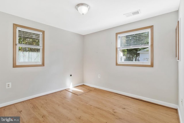 unfurnished room featuring light hardwood / wood-style floors