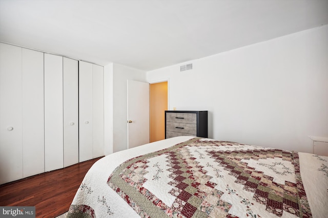 bedroom featuring dark hardwood / wood-style floors and a closet