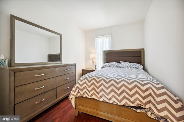 bedroom with dark hardwood / wood-style flooring