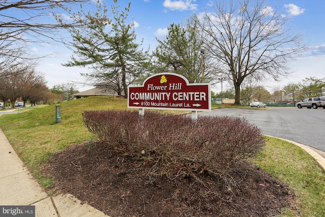 community sign featuring a lawn