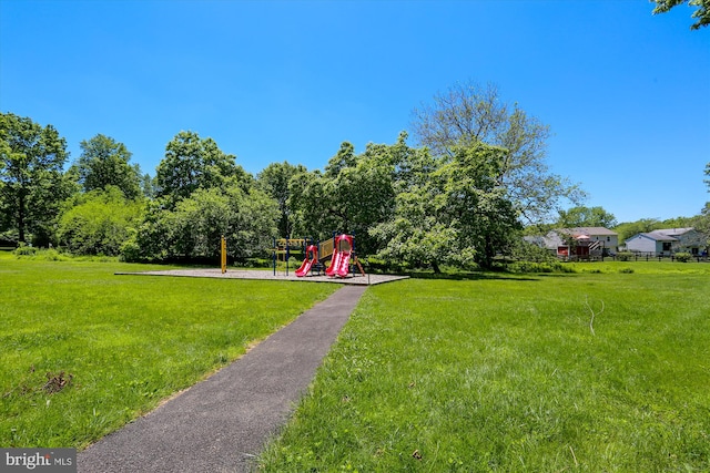 view of community featuring a playground and a lawn