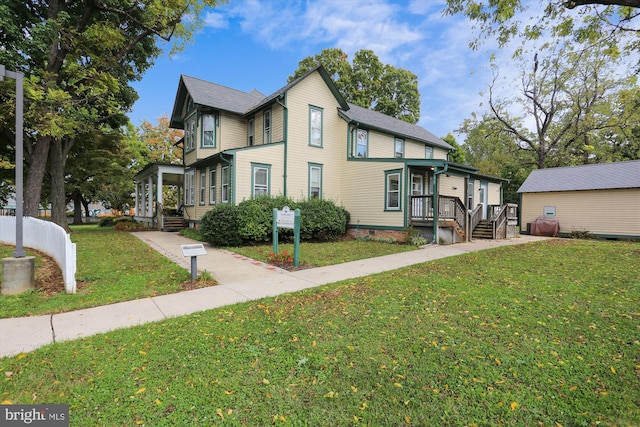 view of front of home featuring covered porch and a front lawn