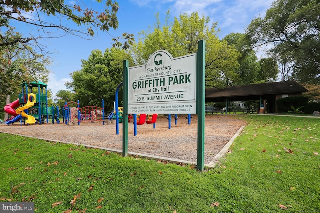 view of property's community featuring a yard and a playground