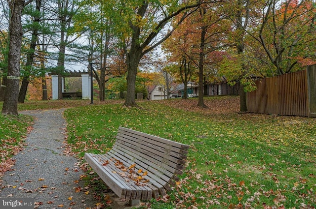 view of community with a pergola and a lawn