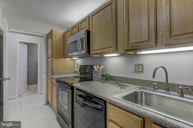 kitchen with light tile patterned flooring, sink, a textured ceiling, and black appliances