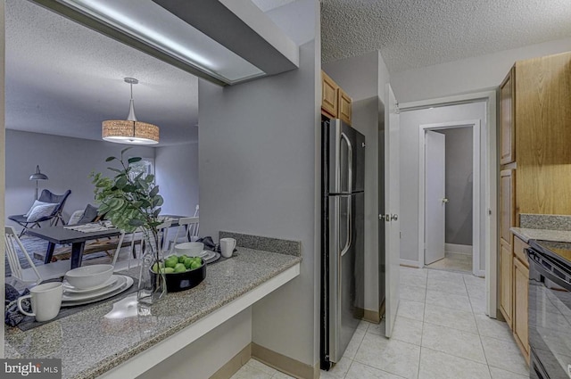 kitchen featuring light tile patterned flooring, black electric range, a textured ceiling, stainless steel fridge, and pendant lighting