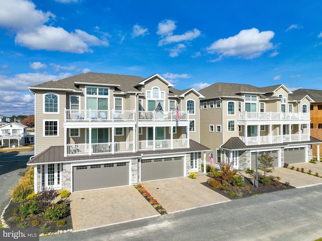 multi unit property featuring a garage and a balcony