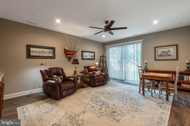 living room with dark hardwood / wood-style floors and ceiling fan