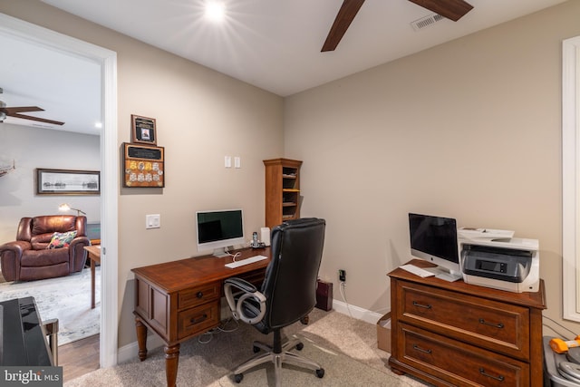 carpeted office with ceiling fan