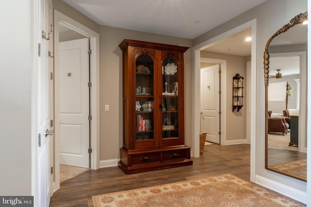 corridor featuring dark wood-type flooring