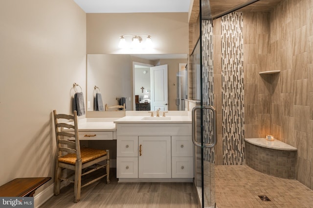 bathroom featuring a shower with door, vanity, and wood-type flooring