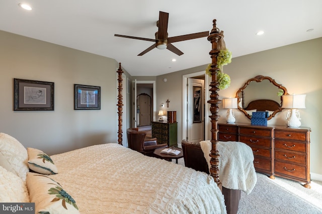 carpeted bedroom with ceiling fan, a walk in closet, and a closet